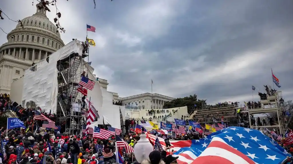 Protesters gather outside the U.S. Capitol, waving American flags and showing support for Trump during the January 6th riots.