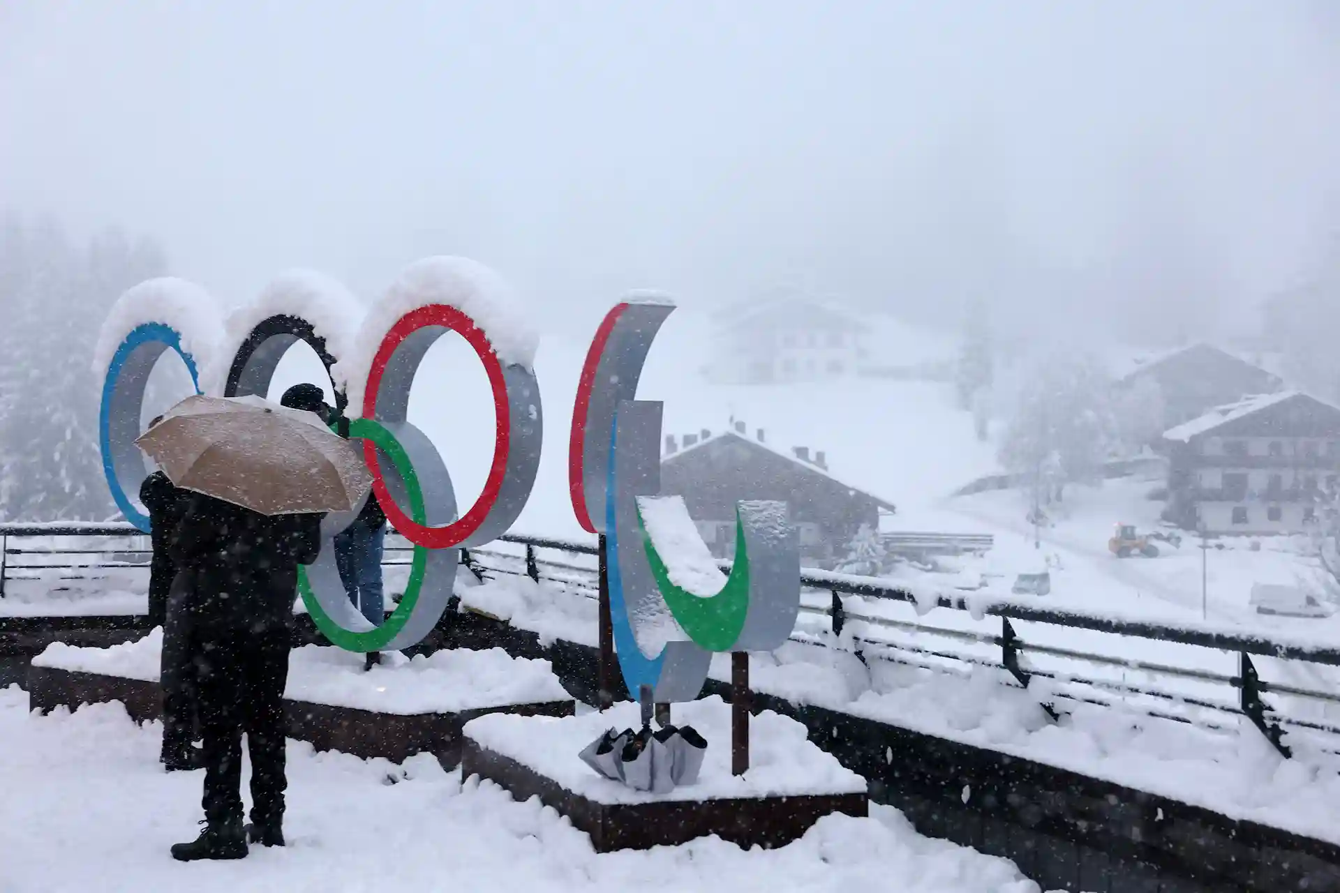 Snow-covered Olympic rings at a mountain venue for Milano Cortina 2026
