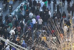 Crowds march through an Iranian city during nationwide economic protests
