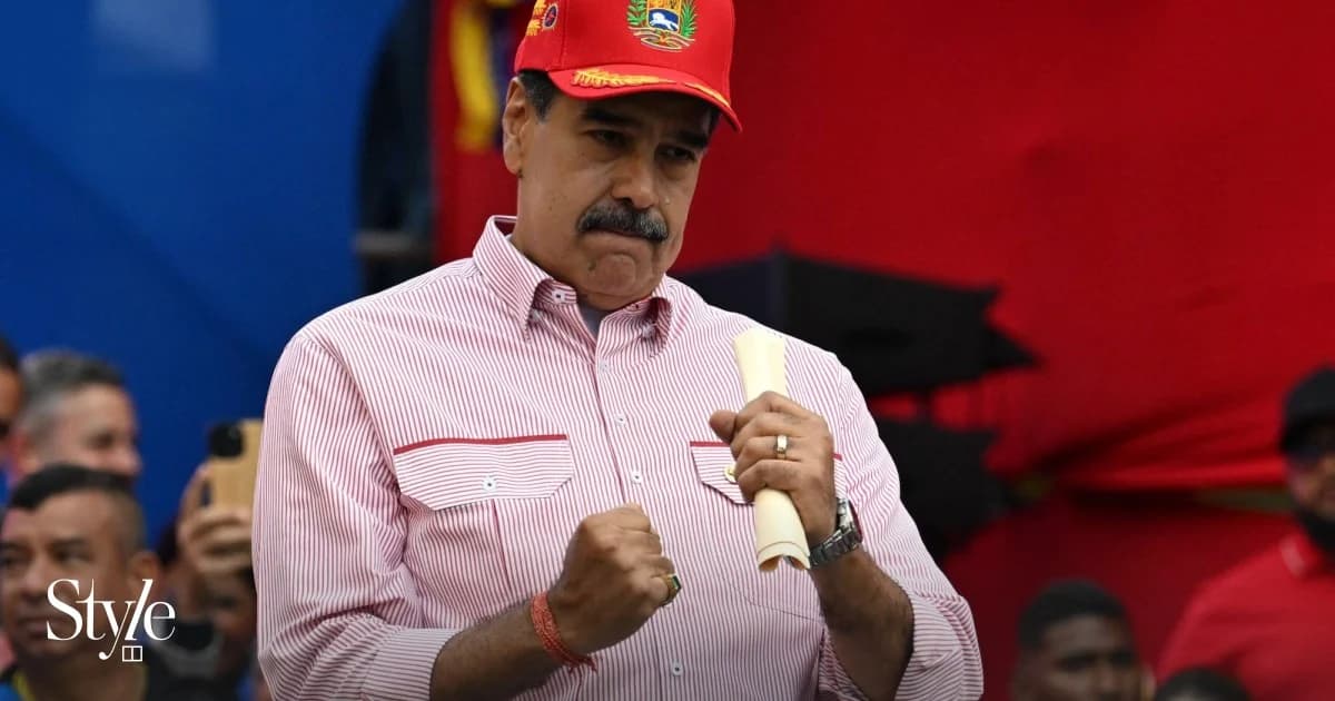 Nicolas Maduro holding document at political event