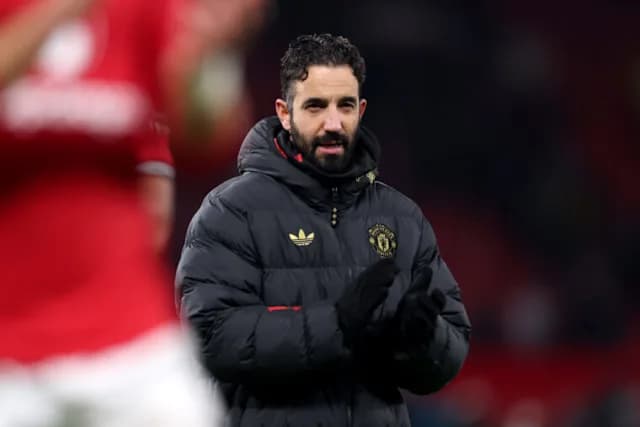 Ruben Amorim applauds on the touchline during a Manchester United match.