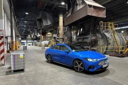 Blue Mercedes-Benz CLA electric sedan showcasing autonomous driving technology