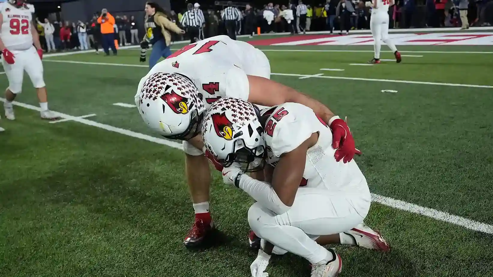 Illinois State players kneel on the field after the overtime loss in the FCS championship.
