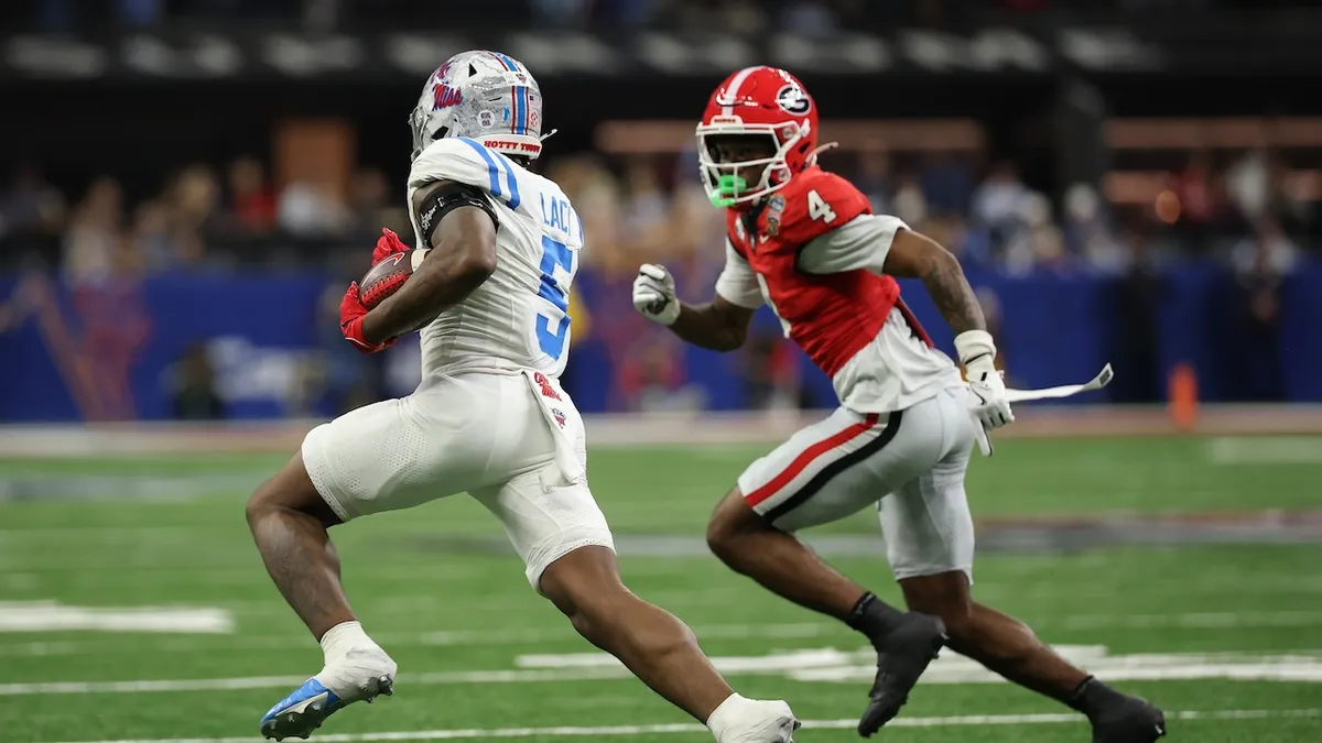Ole Miss quarterback Trinidad Chambliss evades a Georgia Bulldogs defender during a key rushing play in the 2026 Sugar Bowl