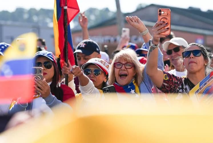 Supporters wave Venezuelan flags and cheer during a public demonstration.