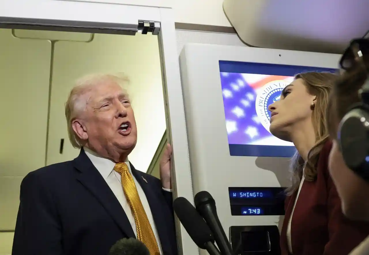 President Donald Trump speaks to reporters inside Air Force One during a press briefing