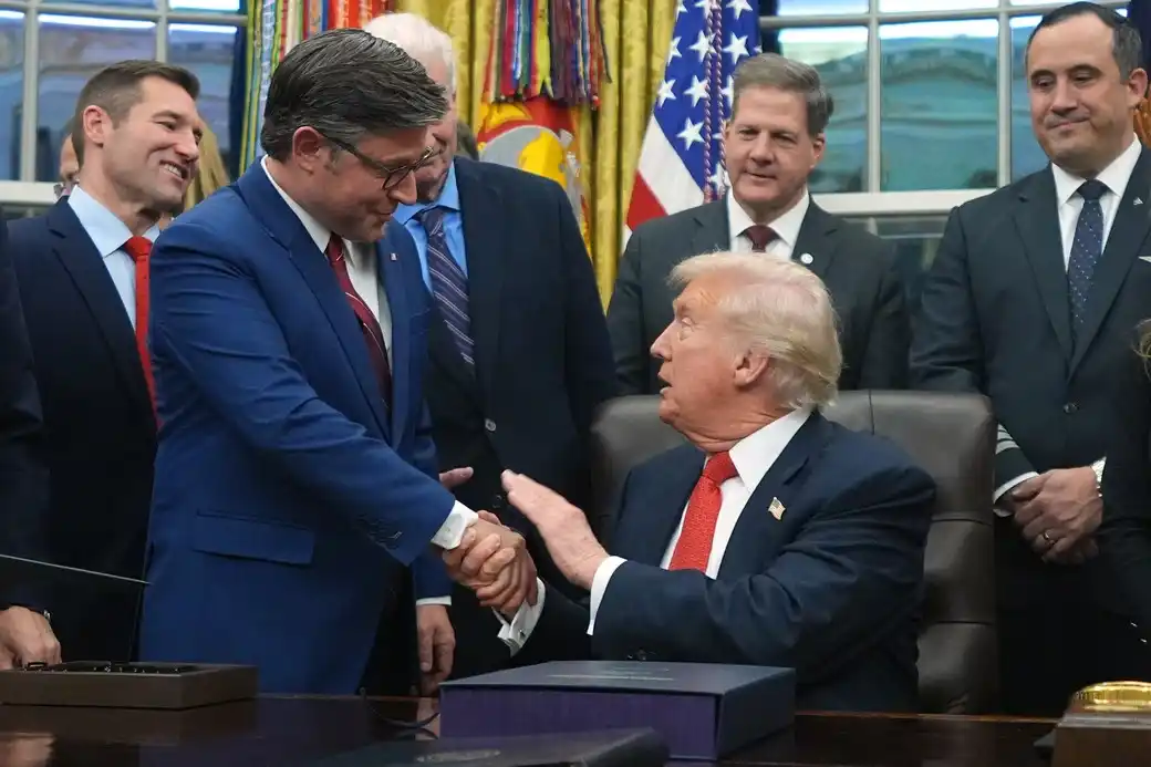 A U.S. president shakes hands with a lawmaker during a meeting in the Oval Office.