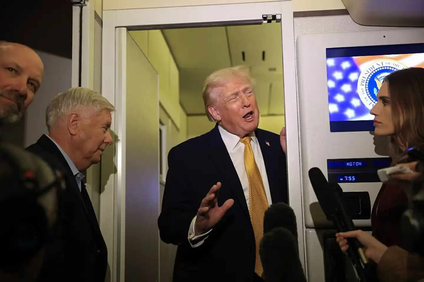 Donald Trump speaking with reporters aboard Air Force One