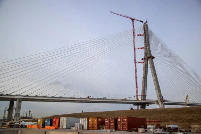 Heavy commercial truck traffic crossing the Ambassador Bridge between Detroit and Windsor, showing congestion at the border
