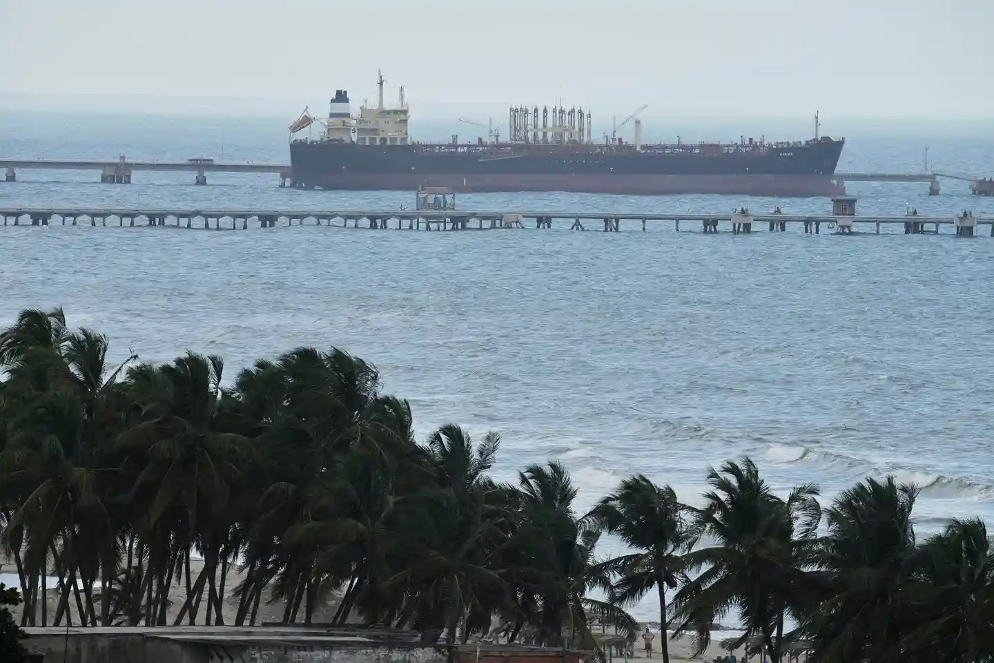 Oil tanker docked at a Venezuelan export terminal with pipelines extending into the sea