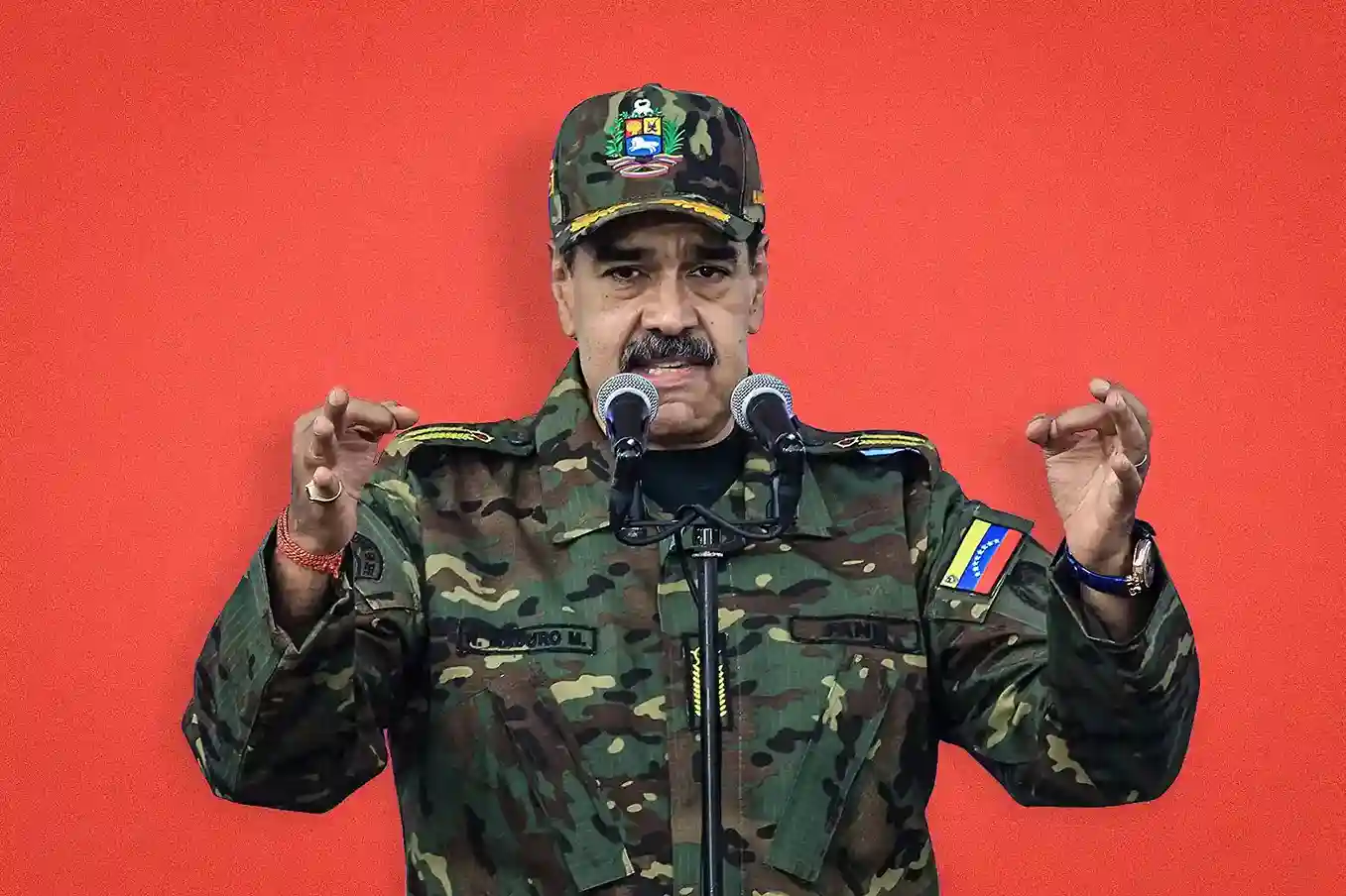 Venezuelan President Nicolás Maduro speaking at a press conference in military uniform.