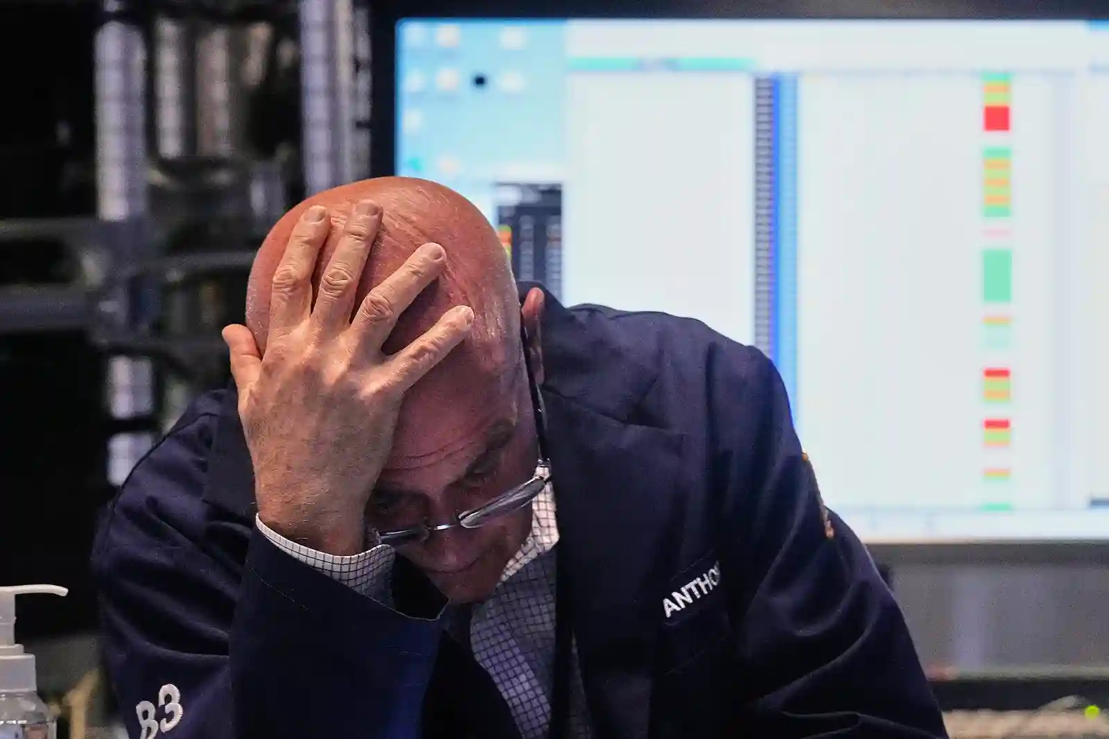 Trader in Wall Street experiencing stress during market volatility