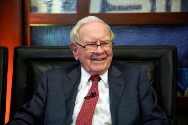 Warren Buffett smiling during a meeting at Berkshire Hathaway